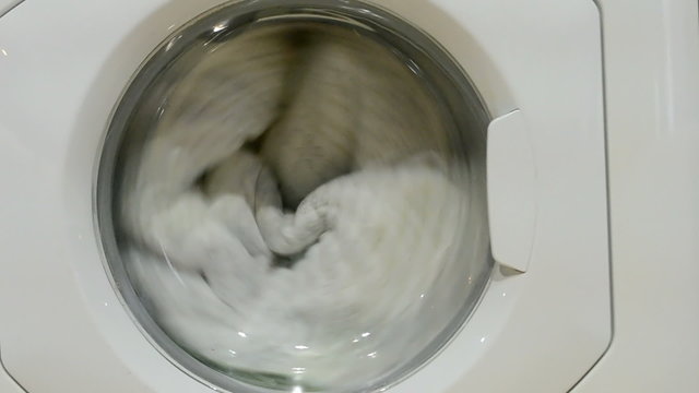 washing machine with white clothing closeup, modern cleaning technology, home equipment diversity