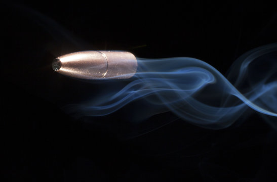 Copper bullet with smoke behind