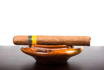 Cuban cigar isolated on wooden bar and white background
