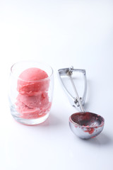 red homemade ice cream scoops in a clear glass with special spoo