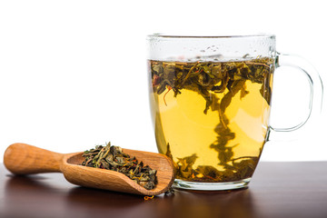 Aromatic antioxidant green tea on wooden board, isolated backgro
