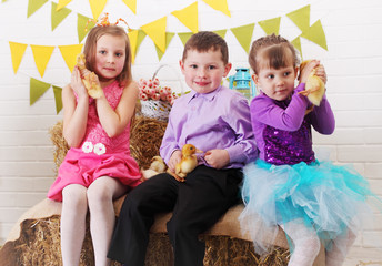 three children with ducklings