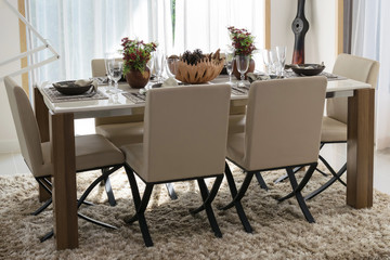 dining table and comfortable chairs in modern home with elegant