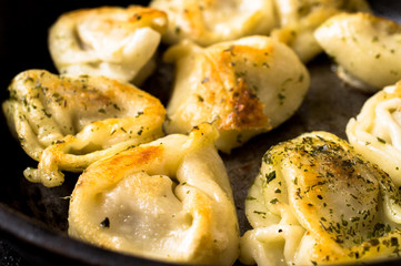 Fried dumplings with beef on rustic pan
