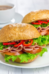 Healthy sandwiches with ham and a cup of hot chocolate