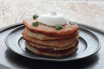 Potato pancakes with sour creme and oregano.