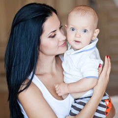 Mother are lovely playing  with baby in bed