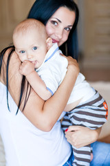 Mother are lovely playing  with baby in bed