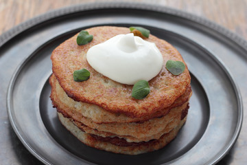 Potato pancakes with sour creme and oregano.