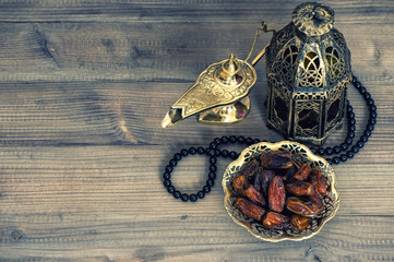 Dates, arabian lantern and rosary. Islamic holidays concept