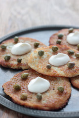 Potato pancakes with sour creme and capers.