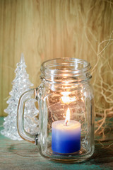 Blue candle in bottle glass