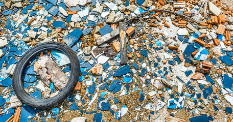 An old tyre in a broken glass zone