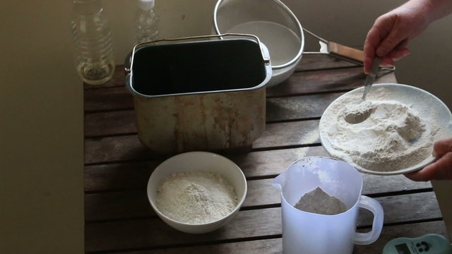 woman hands weigh white flour
