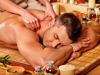 Obraz na płótnie Canvas man getting bamboo massage.