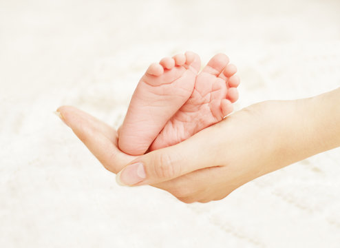 Baby Newborn Feet Mother Hands. New Born Kid Foot, Family Love