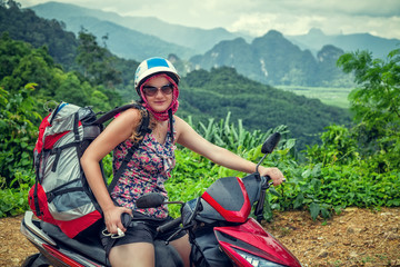 Girl backpacker on motorbike
