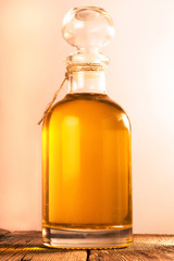 Bottle with  oil on a wooden surface