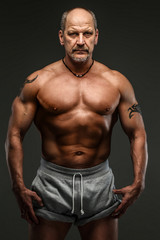 Fototapeta na wymiar Strong muscular middle age man