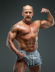 Fototapeta na wymiar Strong muscular middle age man