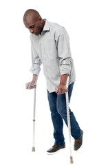 Young man with crutches trying to walk