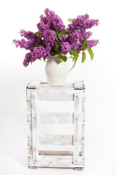 lilacs and lilies of the valley on a wooden crate - decoration