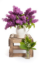 lilacs and lilies of the valley on a wooden crate - decoration