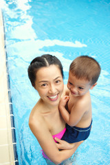 Happy mother and son in the pool