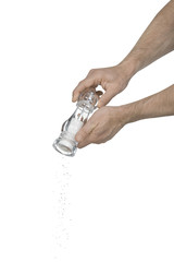Two male hands using a salt grinder