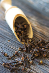 Cloves on vintage wooden background