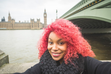 Obraz premium Girl taking selfie in London with Big Ben on background