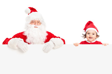Santa and a girl standing behind signboard