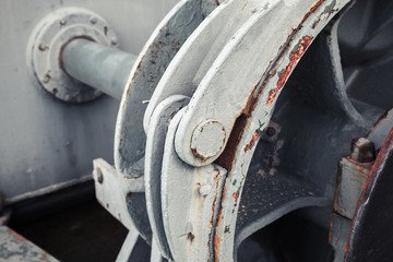 Old winch fragment with big shaft. Selective focus