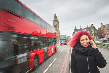 Beautiful woman talking on mobile with Big Ben on background