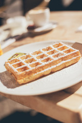 Waffle Dusted with Icing Sugar on Plate