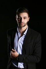 young fashion man model on black background