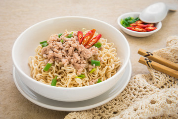 Instant noodles with pork in bowl