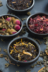 assortment of dry tea in ceramic bowls, close-up, top view