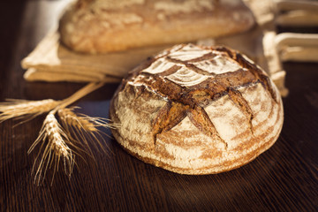 Rustic bread and wheat on a traditional cloth bag