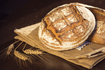 Rustic bread and wheat on a traditional cloth bag