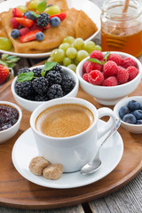 breakfast with coffee, fresh berries and pancakes, vertical