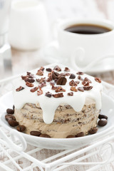 coffee cake with icing decorated with cocoa beans, vertical