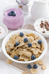 crunchy flakes with blueberry and various yogurts for breakfast