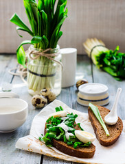 rye bread with wild garlic, sour cream and quail eggs