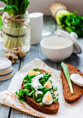 rye bread with wild garlic, sour cream and quail eggs