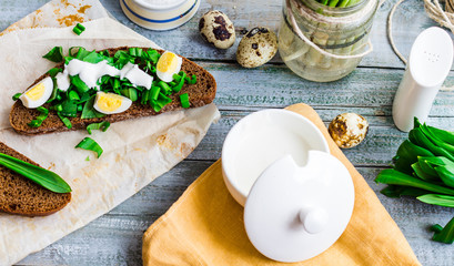 rye bread with wild garlic, sour cream and quail eggs
