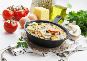 Omelet with mushrooms and tomatoes. Frittata