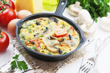 Omelet with mushrooms and tomatoes. Frittata