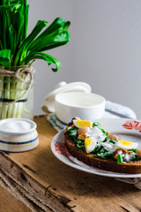 leek with quail eggs and sour cream on rye bread, snack
