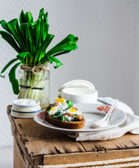 leek with quail eggs and sour cream on rye bread, snack